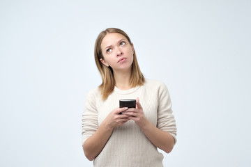 Split up message for boyfriend. Young cute attractive woman is writing some text or using a smart...