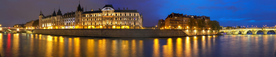 Panorama of Seine river , Conciergerie between Pont au Change i and pont Neuf n Paris at night, France.