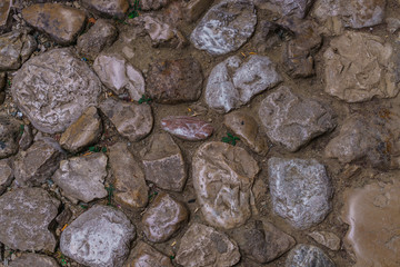 Background texture, limestone, basalt, cobblestone, granite, pebble. The laid out cobblestones used to lay the road