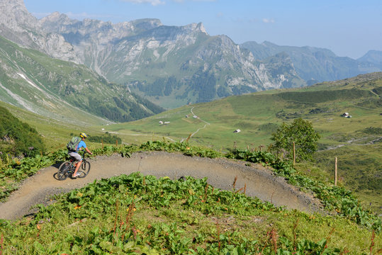 Boy on his mountain bike going down the path from Jochpass
