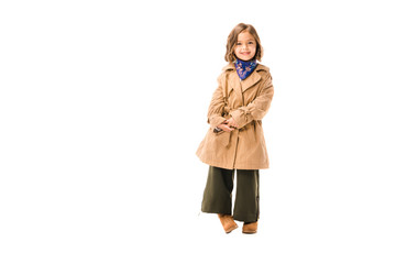 beautiful little child in trench coat looking at camera isolated on white