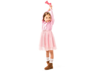 cute kid in pink dress holding gamepad isolated on white