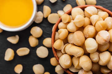 delicious macadamia nuts on a dark stone background