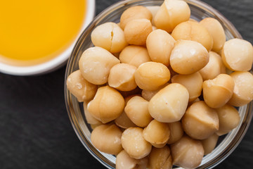 delicious macadamia nuts on a dark stone background