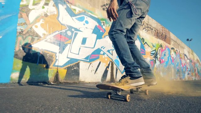 A man jumping on his skate, slow motion. Person doing tricks on his skateboard, jumping on it.