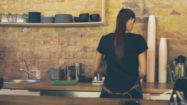 Smiling waitress giving cup of coffee to the customer