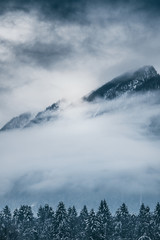 Fototapeta na wymiar Cloudy landscape in Winter mountains