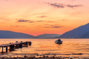 Beautiful sunset with pier and fishing boat