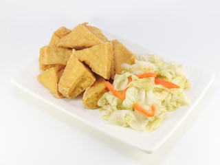 High angle view of fried stinky tofu with pickle vegetable isolated on white background. Traditional snack at night market. Oriental,Asia,Taiwan food concept.With copy space.