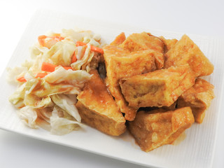 High angle view of fried stinky tofu with pickle vegetable isolated on white background. Traditional snack at night market. Oriental,Asia,Taiwan food concept.With copy space.