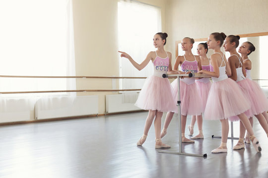 Ballerinas having break in practice at ballet studio