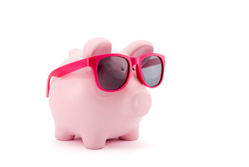 Piggy bank with pink glasses on white background 
