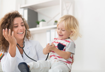 Baby playing with stethoscope in doctor's office