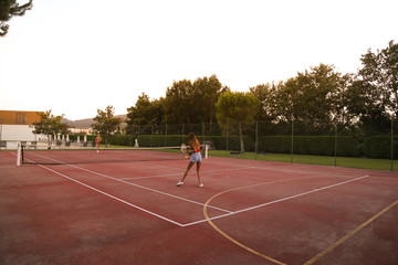 Fototapeta premium Couple playing tennis at the court