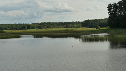 Staw o nazwie "Echo" na Roztoczu. Wschodnia Polska.  Miejsce wypoczynku i hodowli małych koni. Lato. Europa. © Marian