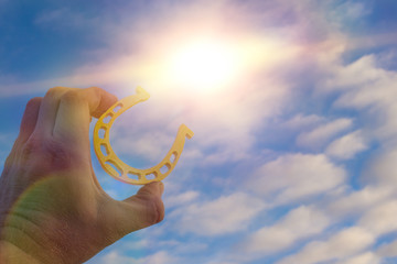 Golden Horseshoe for good luck in the hand of a businessman. Business concept idea, luck, success,...