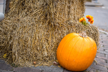 Halloween pumpkin and hay decorations.