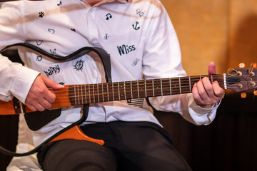 guitarist plays.chord on an electric guitar.Close up of an electric guitar being played.