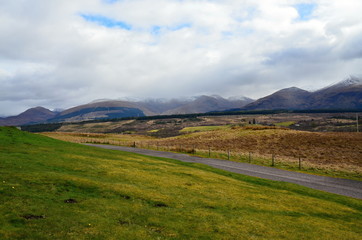 Scottish Highlands overlooking the countryside with green and white hills 