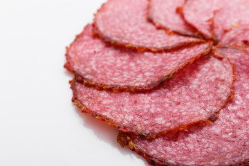 delicious sliced salami on a white background