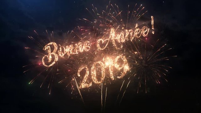 2019 Happy New Year greeting text in French with particles and sparks on black night sky with colored slow motion fireworks on background, beautiful typography magic design.