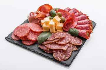 Cold smoked meat plate on a white background