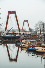 The Red Bridge (Willemsbrug) in Rotterdam Holland with its reflection on a river