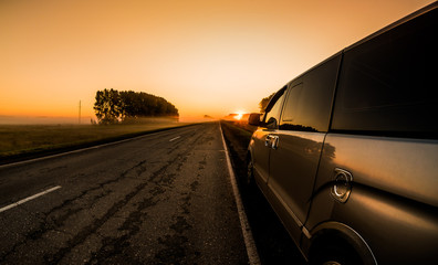 A minibus standing on the roadside in a peaceful misty summer morning, in anticipation of a journey...