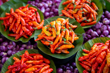 Exotic Red Chilli on banana leaves with purple background 