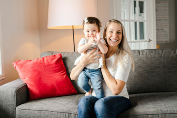 Portrait of little girl with mother on the living room