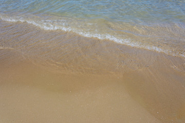 Fototapeta na wymiar natural background. sea surf on the sandy beach