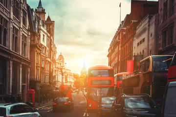 Oxford Street in London against golden sun ray while after work 