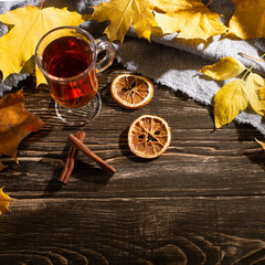 A cup of autumn tea and yellow dry leaves. Copy space. Hot drink for autumn cold rainy days. Hygge concept, autumn mood. flat lay