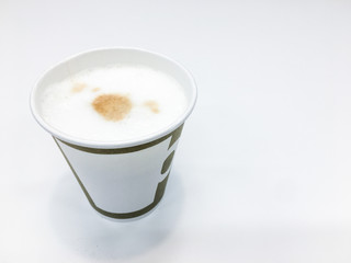 A paper cup of hot coffee with milk foam.