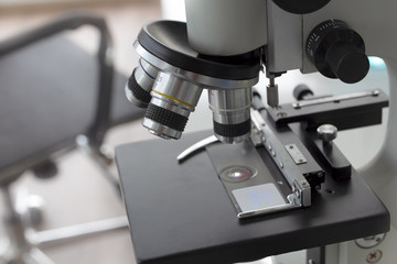 Fototapeta na wymiar Close-up shot of examining test sample under the microscope in laboratory.