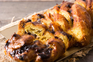 Homemade braid chocolate on wooden table. Close up