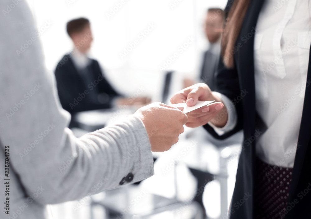 Wall mural close up.two business woman exchanging business card