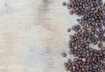 Wooden board with coffee grains.