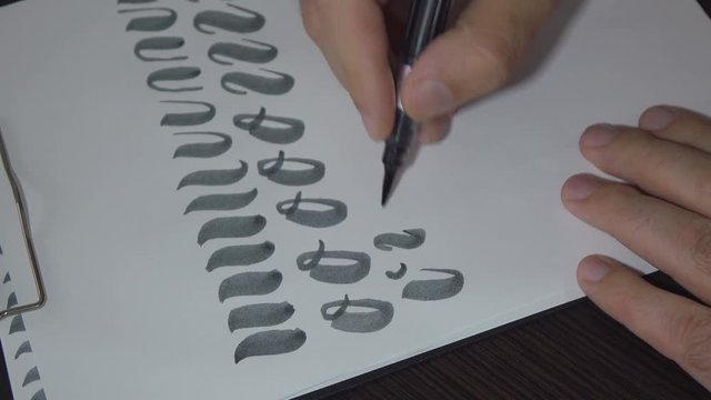 Man practiced in hand lettering with brush pen