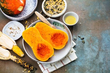 Pumpkin with different vegetables on the old wooden table top view ,Butternut