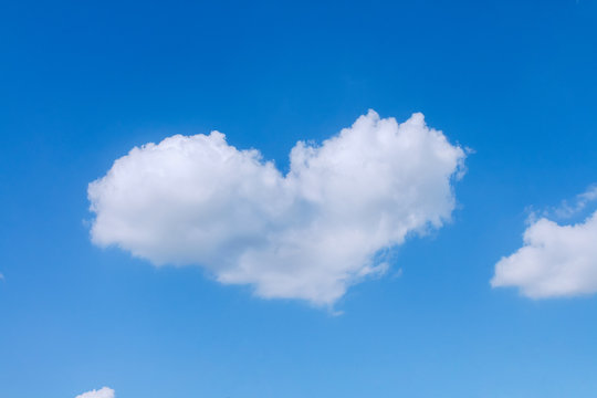 One white heart shaped cloud floating in the sky