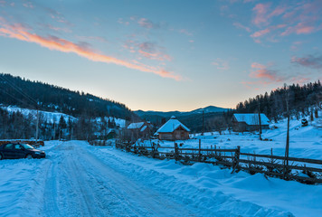 Daybreak sunrise morning winter mountain village snow covered street