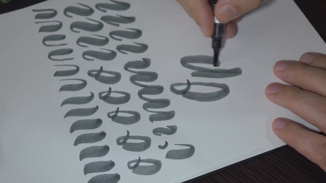 Man practiced in hand lettering with brush pen