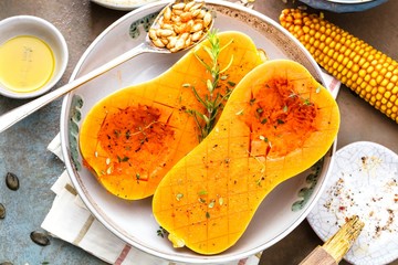 Pumpkin with different vegetables on the old wooden table top view ,Butternut