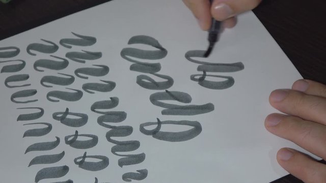 Man practiced in hand lettering with brush pen