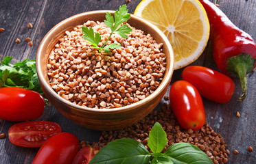 Bowl of buckwheat kasha on wooden table