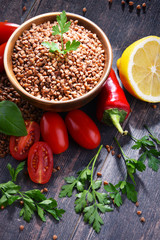 Bowl of buckwheat kasha on wooden table