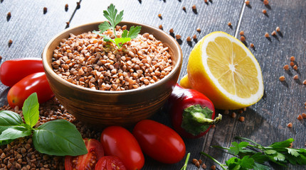Bowl of buckwheat kasha on wooden table