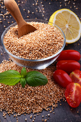 Bowl of amaranth grain on wooden table