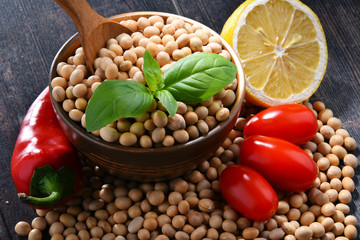 Composition with bowl of soya beans on wooden table